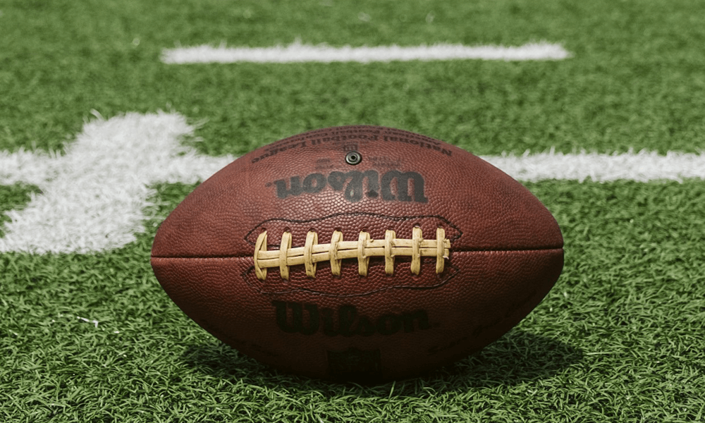 American football field with leather ball