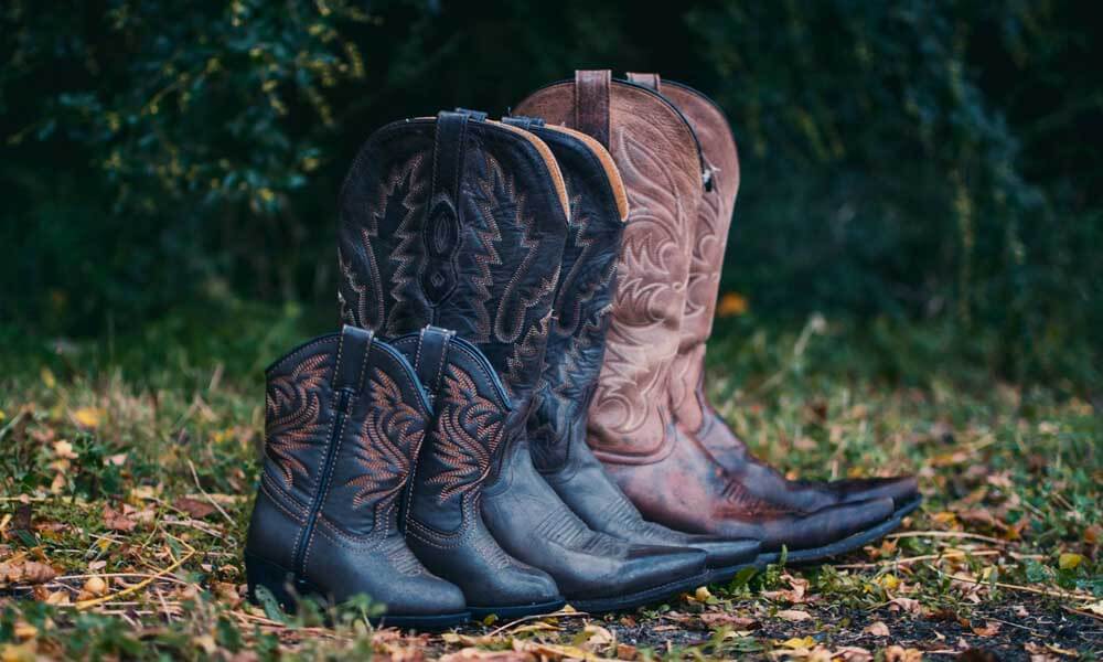 Three different sizes of beautifully crafted cowboy leather boots