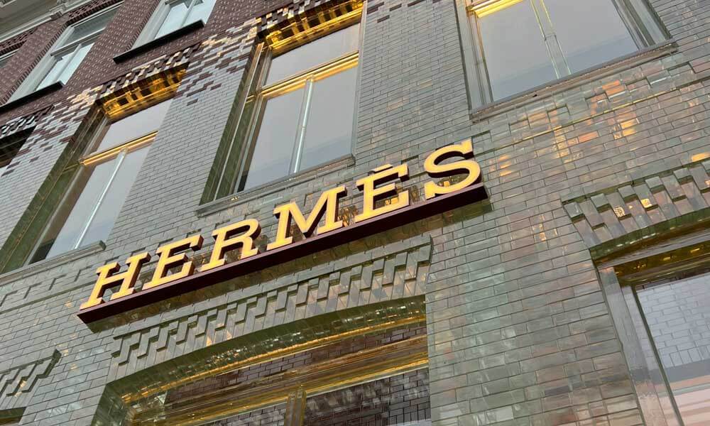 Brick building with Hermes sign lit up