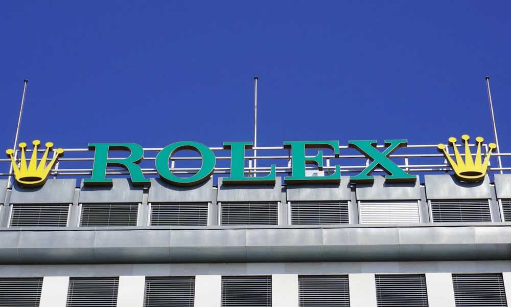 Rolex watches sign with crown logo on top of a building