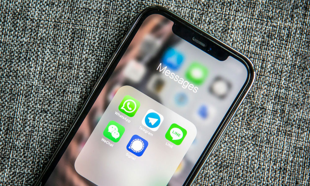 iPhone screen with WhatApp and other messaging app icons