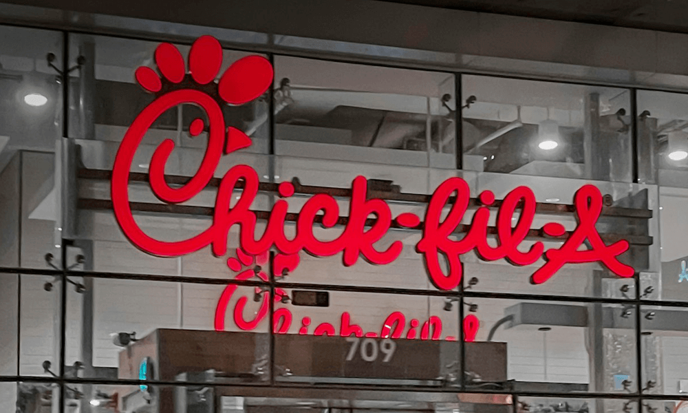 Red Chick-fil-a logo sign in front of store