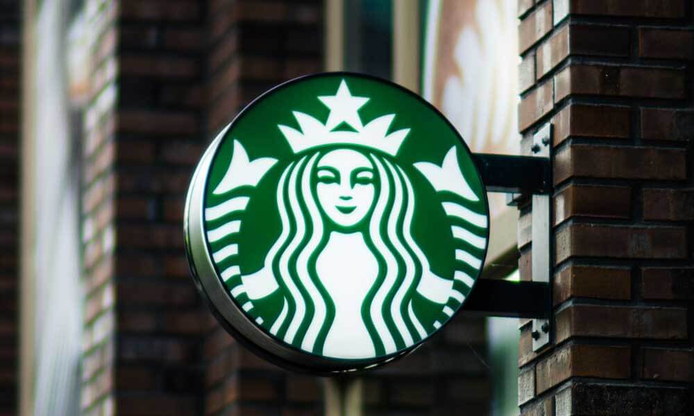 Starbucks Mermaid logo sign on brick wall